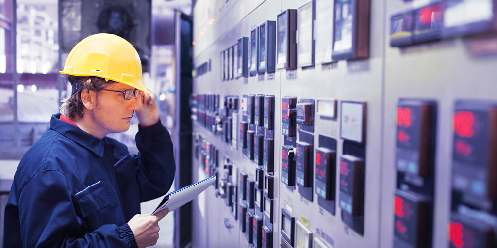 Operator Looking at Meters in a Panel